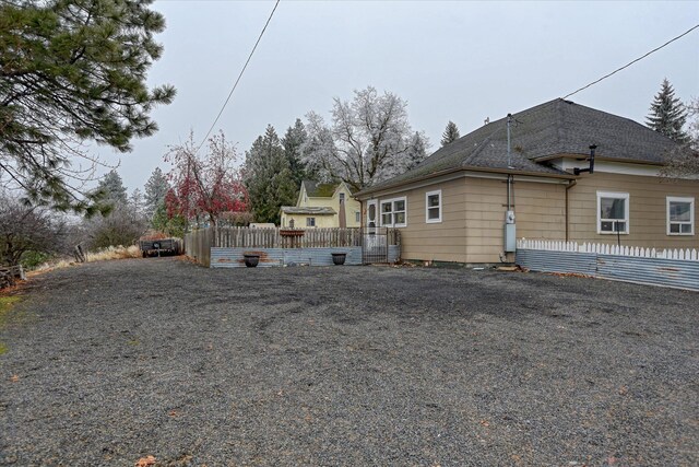 bungalow with covered porch and a front lawn