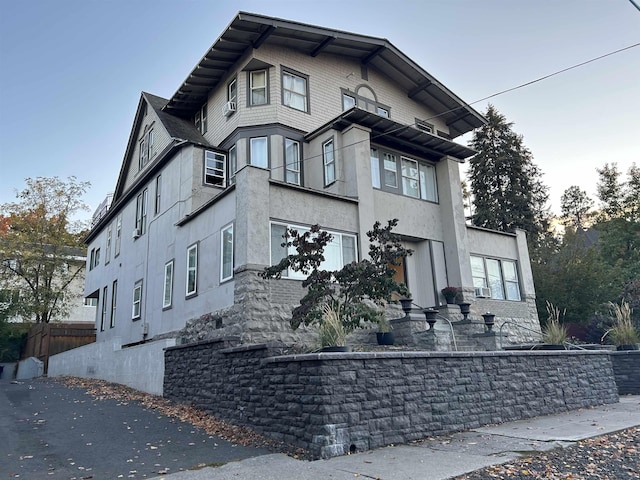 view of side of home with stucco siding