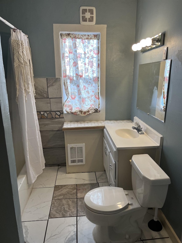 full bathroom featuring vanity, shower / bath combination with curtain, and toilet