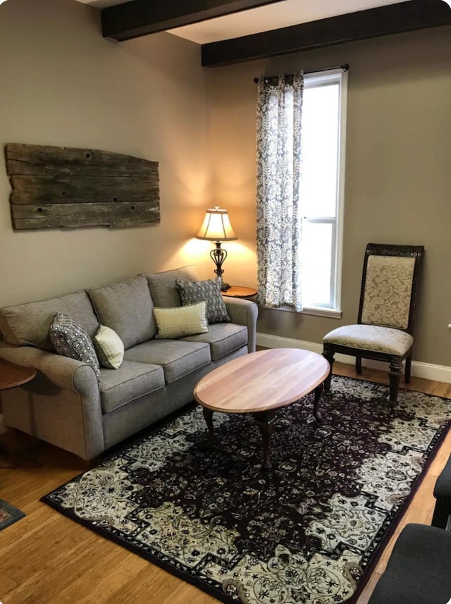 living room featuring hardwood / wood-style flooring and beamed ceiling