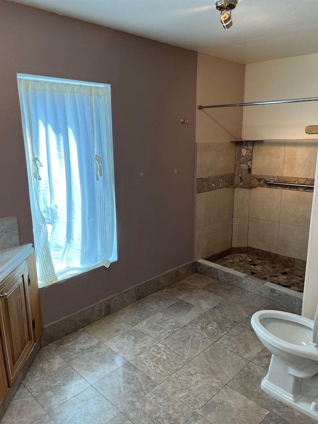 bathroom with vanity and tiled shower