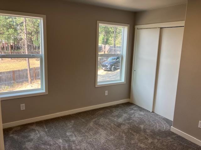 38105 N Frontage Rd, Elk, WA 99009 - unfurnished bedroom with dark carpet and a closet