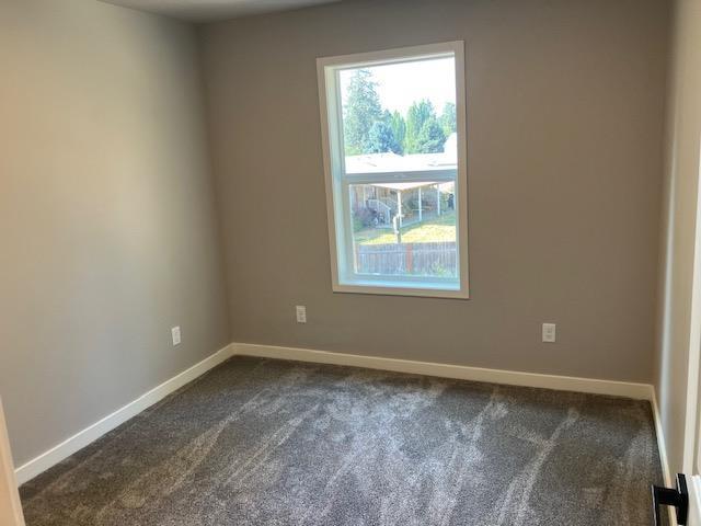 38105 N Frontage Rd, Elk, WA 99009 - unfurnished room featuring dark colored carpet and baseboards