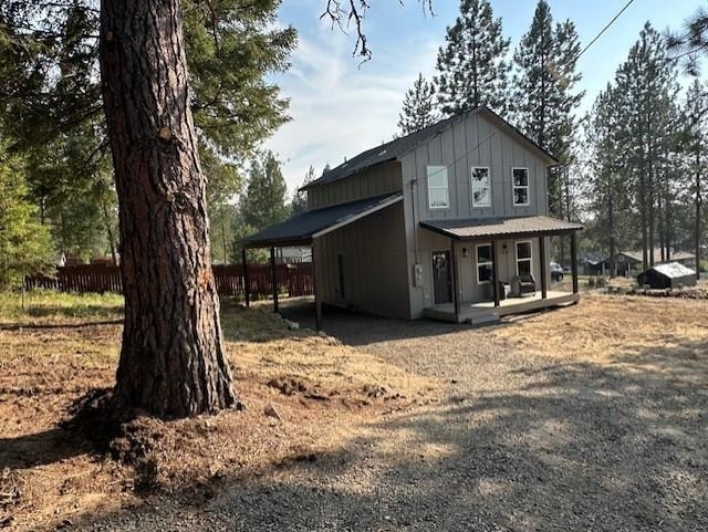 38105 N Frontage Rd, Elk, WA 99009 - back of property with covered porch, board and batten siding, and an attached carport