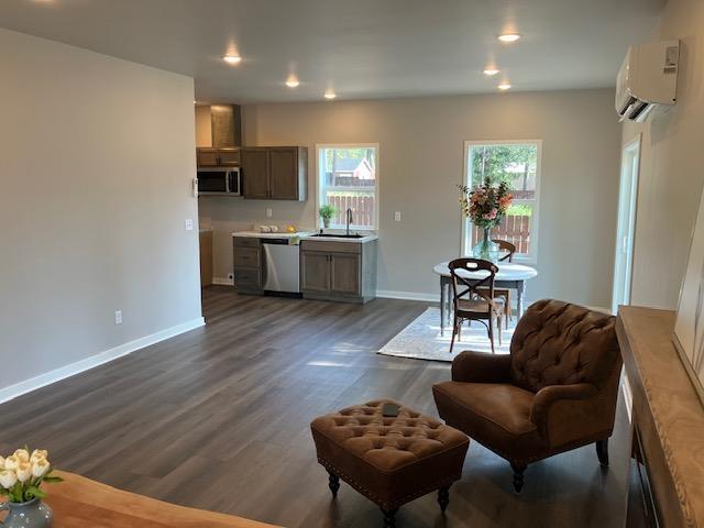 38105 N Frontage Rd, Elk, WA 99009 - kitchen featuring stainless steel appliances, a wall mounted AC, dark wood finished floors, recessed lighting, and light countertops