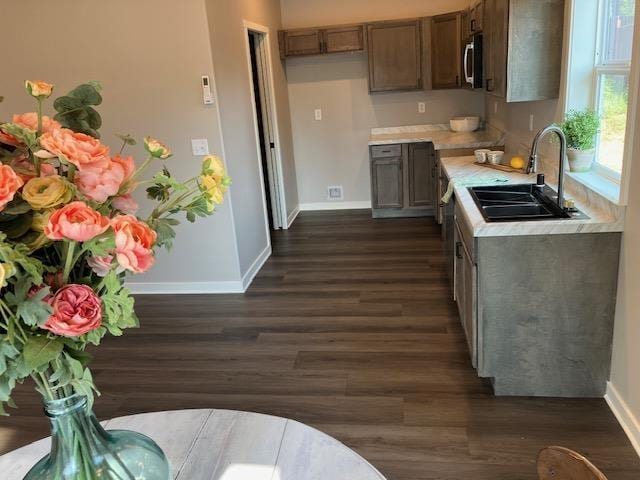 38105 N Frontage Rd, Elk, WA 99009 - kitchen featuring light countertops, dark wood-type flooring, appliances with stainless steel finishes, and brown cabinets