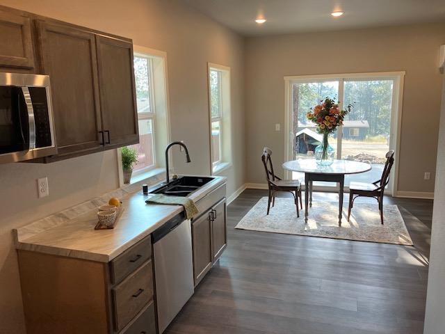 38105 N Frontage Rd, Elk, WA 99009 - kitchen with stainless steel appliances, light countertops, dark wood-style floors, and recessed lighting