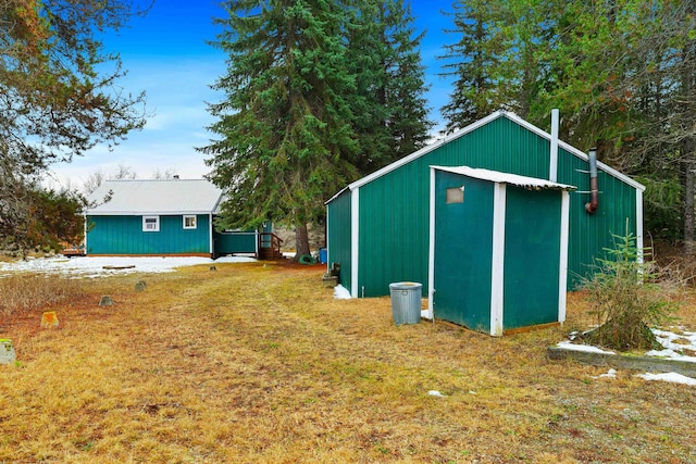 view of outbuilding featuring a lawn