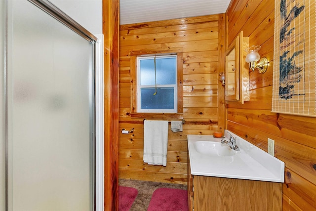 bathroom with vanity, a shower with door, and wooden walls