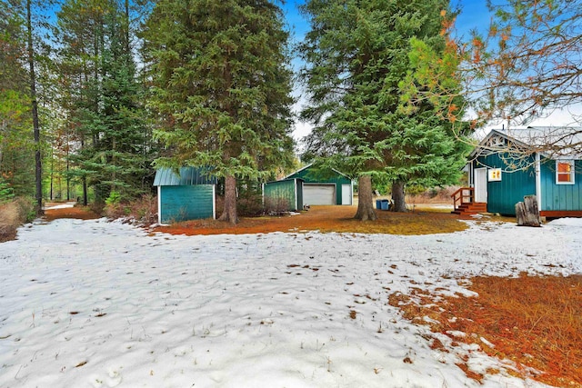 snowy yard featuring an outdoor structure