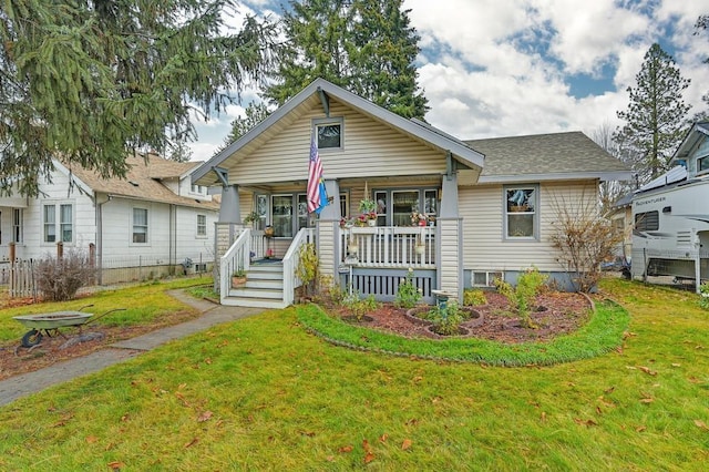 bungalow-style home with a front lawn and a porch