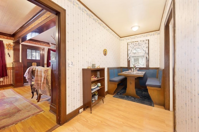 corridor featuring light hardwood / wood-style floors and crown molding