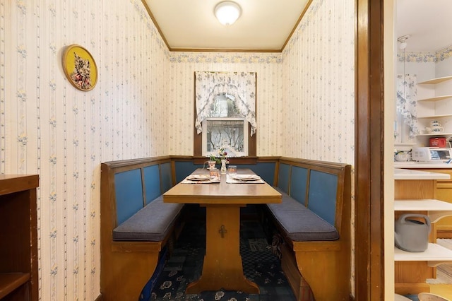 dining room featuring breakfast area and ornamental molding