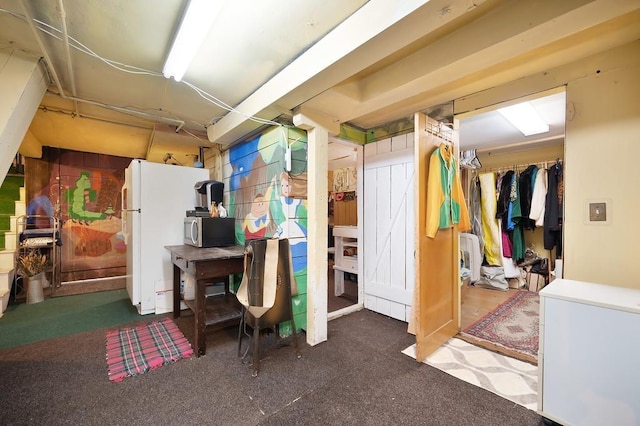 interior space featuring white fridge and dark carpet