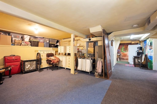 interior space featuring white fridge and dark colored carpet