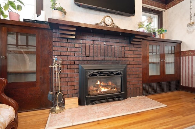 room details with hardwood / wood-style floors and a fireplace