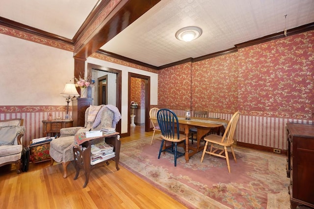 dining room featuring hardwood / wood-style floors and ornamental molding