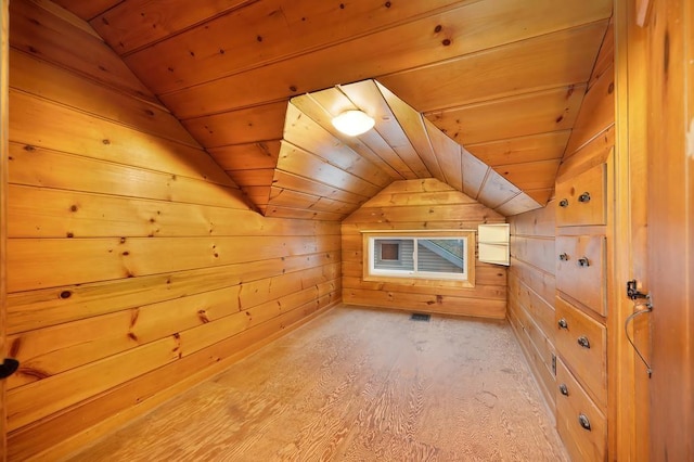 additional living space with light hardwood / wood-style floors, wood walls, and wooden ceiling