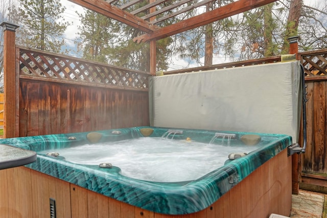 view of patio / terrace featuring a pergola and a hot tub