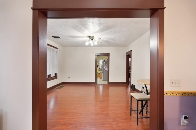 spare room featuring hardwood / wood-style floors and ceiling fan