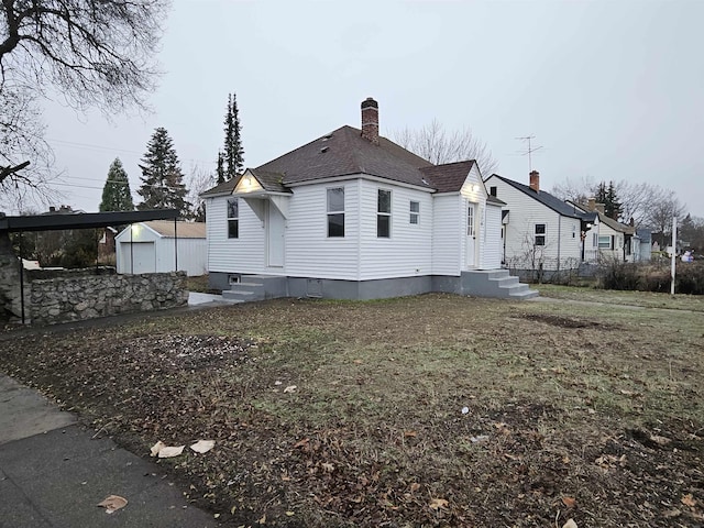 exterior space with a garage and an outdoor structure