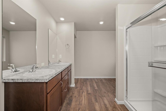 bathroom featuring hardwood / wood-style floors, vanity, and walk in shower