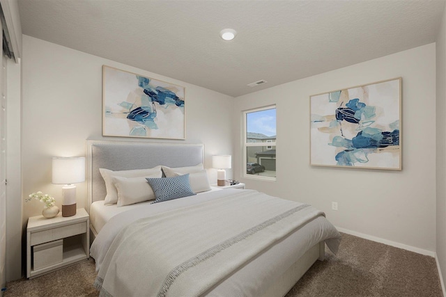 carpeted bedroom with a textured ceiling