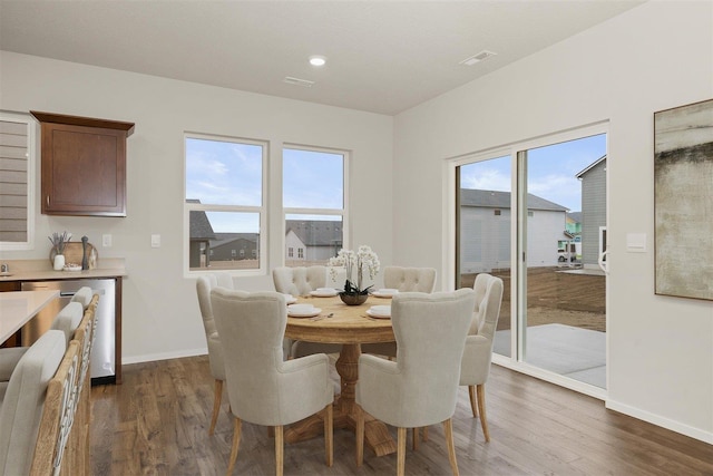 dining area with dark hardwood / wood-style flooring