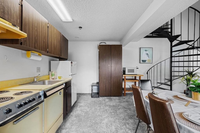 kitchen featuring sink, a textured ceiling, white appliances, light carpet, and exhaust hood