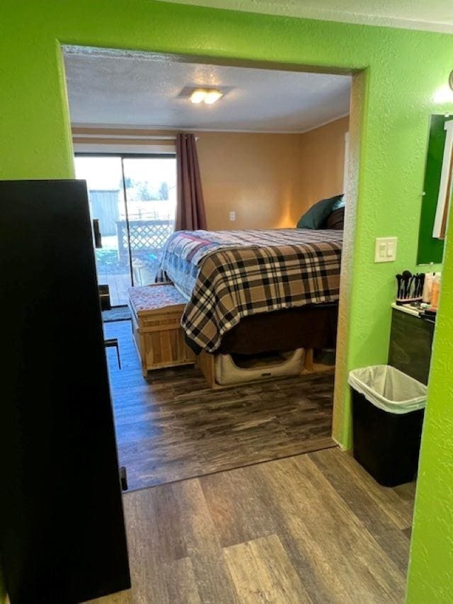 bedroom featuring access to exterior and hardwood / wood-style floors