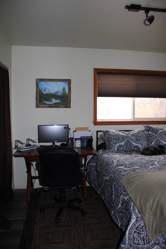 bedroom with dark wood-type flooring