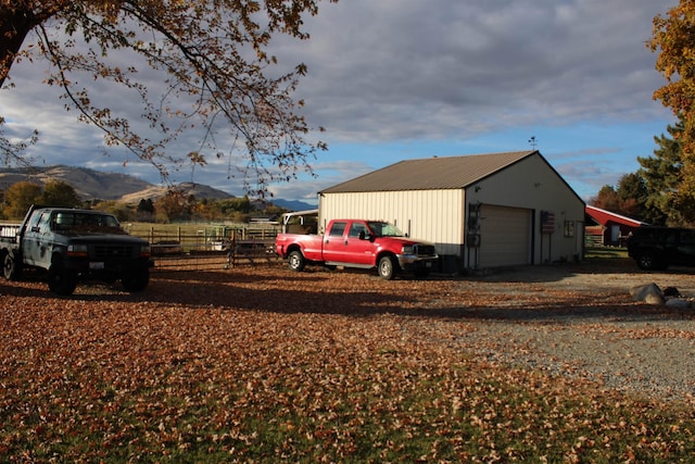 view of outdoor structure with a mountain view and a garage