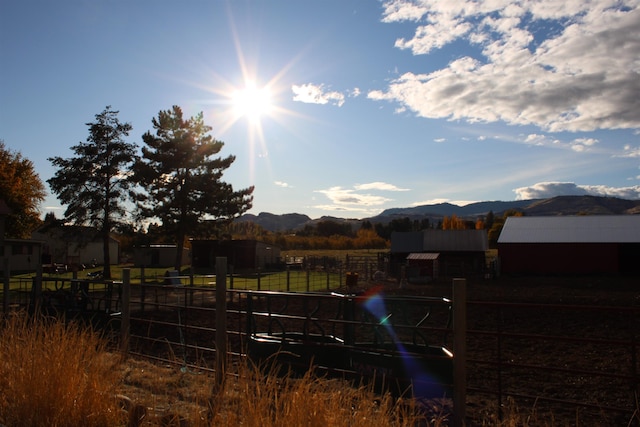 view of yard with a mountain view and a rural view