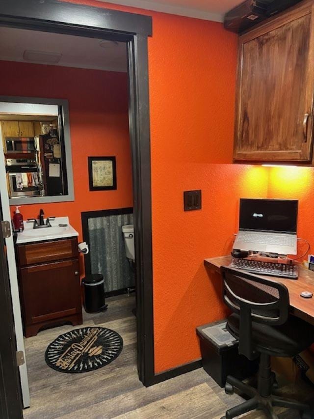 office space featuring sink and light hardwood / wood-style flooring