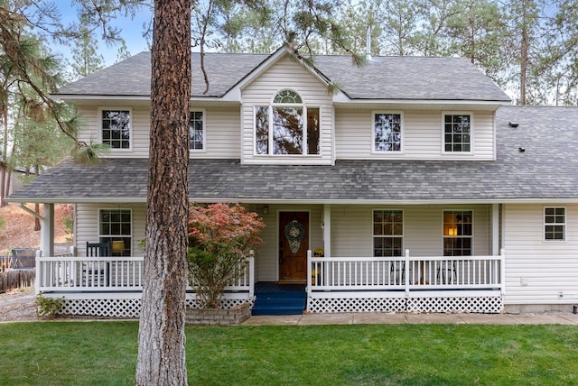 view of front of house with covered porch and a front yard