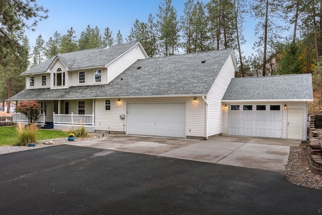 view of front of house with a porch and a garage