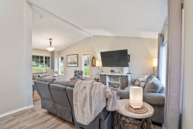 living room with lofted ceiling with beams and light wood-type flooring