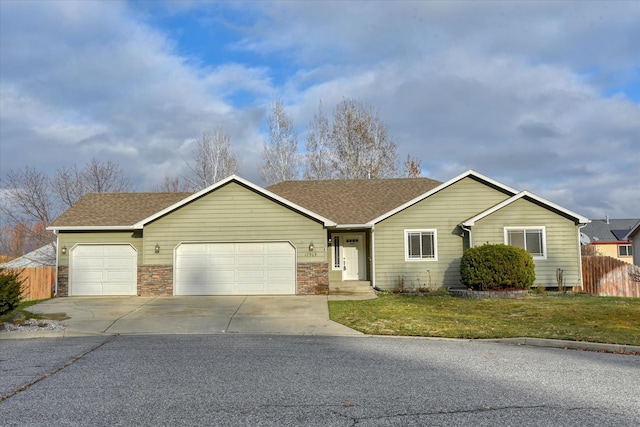 ranch-style home with a front yard and a garage