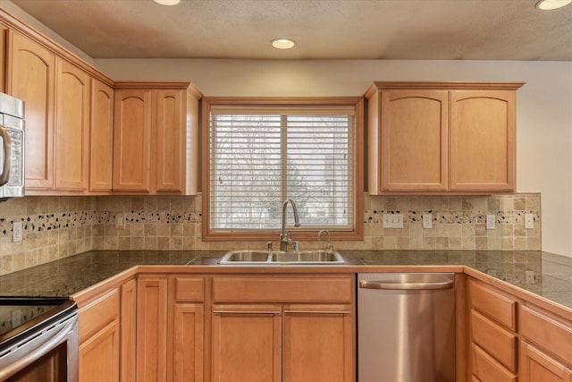 kitchen featuring decorative backsplash, light brown cabinets, sink, and stainless steel appliances