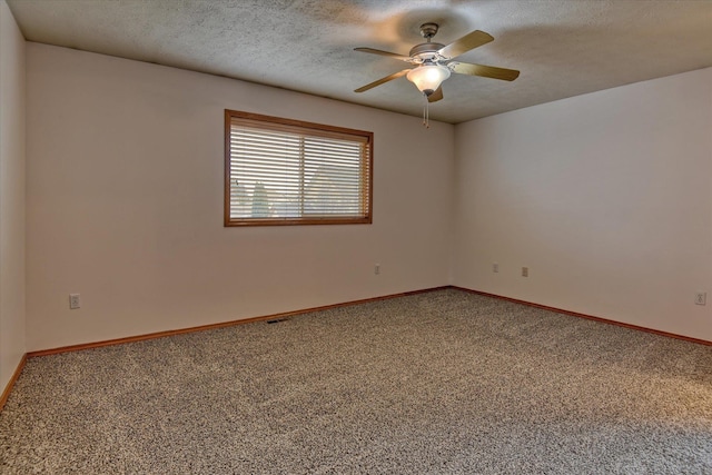 carpeted spare room with a textured ceiling and ceiling fan