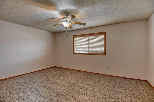 unfurnished room with carpet flooring and a textured ceiling