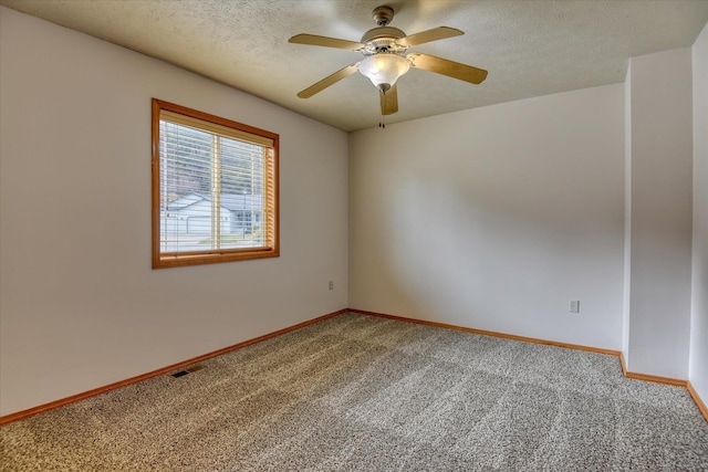 spare room with carpet flooring, a textured ceiling, and ceiling fan