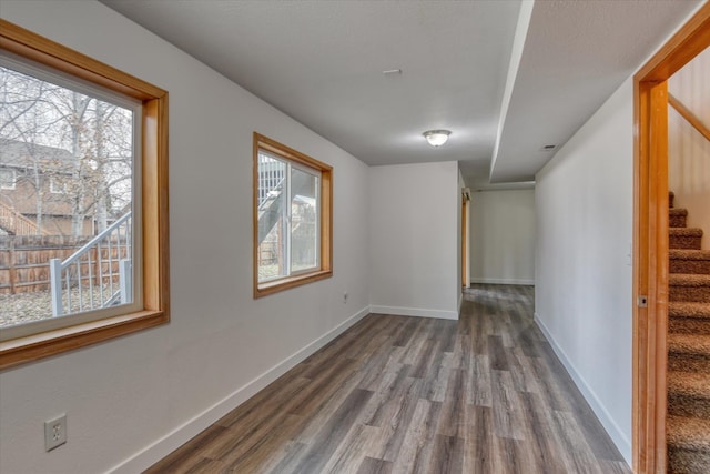 unfurnished room with hardwood / wood-style flooring and a healthy amount of sunlight