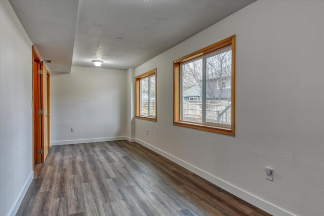 unfurnished room with hardwood / wood-style flooring