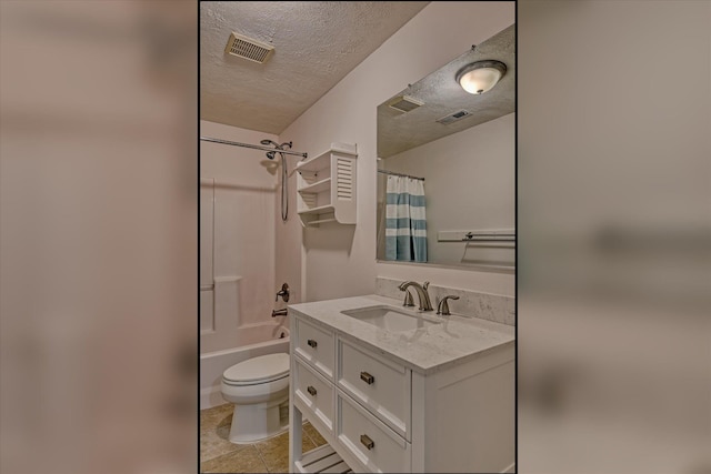 full bathroom with tile patterned floors, a textured ceiling, toilet, shower / tub combo with curtain, and vanity