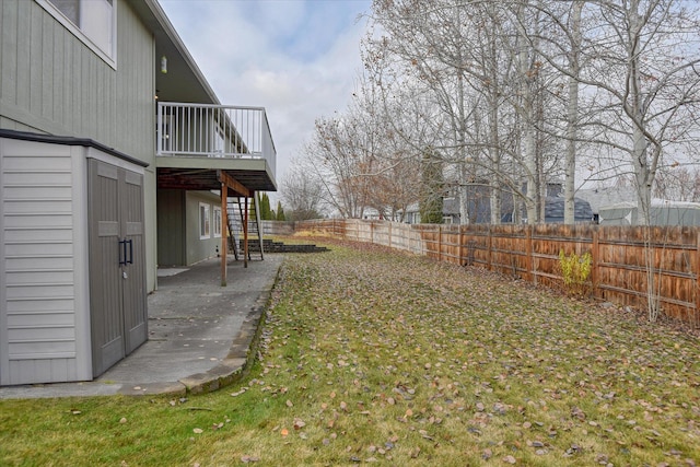 view of yard featuring a patio area and a wooden deck