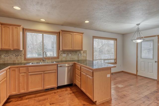 kitchen featuring light wood-type flooring, sink, pendant lighting, light brown cabinets, and dishwasher