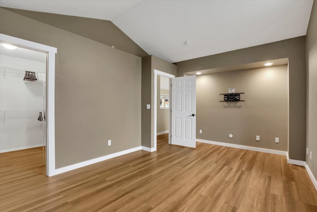 empty room featuring light hardwood / wood-style floors and lofted ceiling