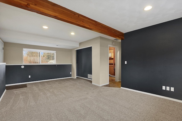 empty room with carpet and beamed ceiling