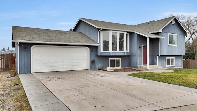 view of front of house with a garage and a front lawn